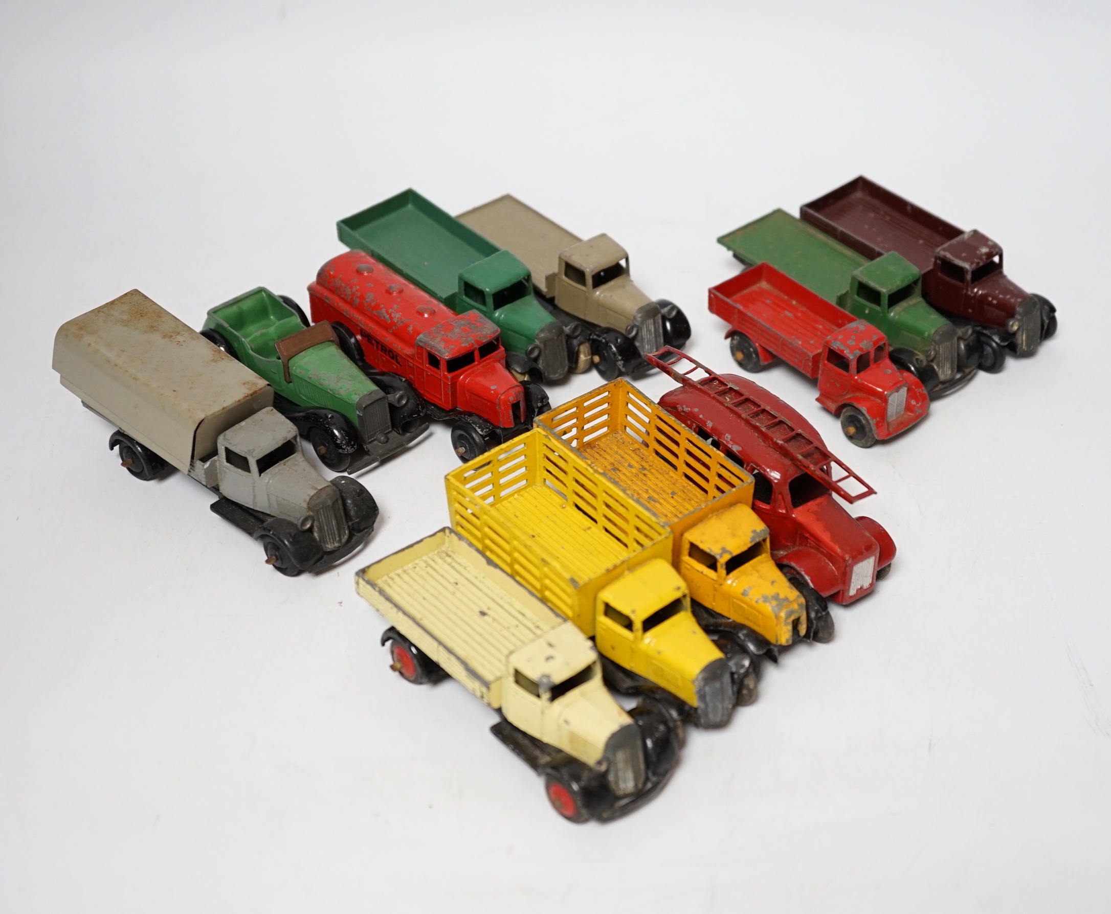 Twenty-five Dinky Toys and Atlas Dinky including a few pre-war examples; Delivery lorries, Market Gardener’s wagon, a Streamlined Fire Engine, a Jaguar SS, Mechanical Horse, etc. together with five Atlas stinky, includin